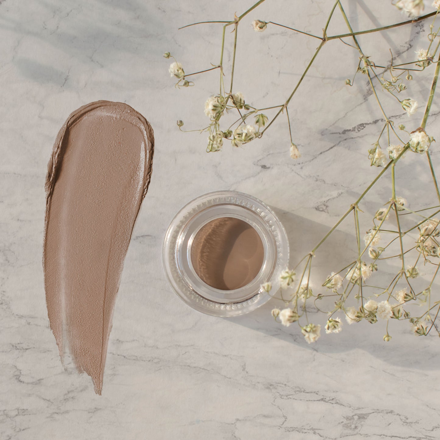 Elevate your brow game with Cruisin Organics' Choco-Latte Brow Pomade. This vegan and cruelty-free formula expertly fills, enhances, and tames brows of all types, while eliminating parabens and fragrance for a defined and healthy look.