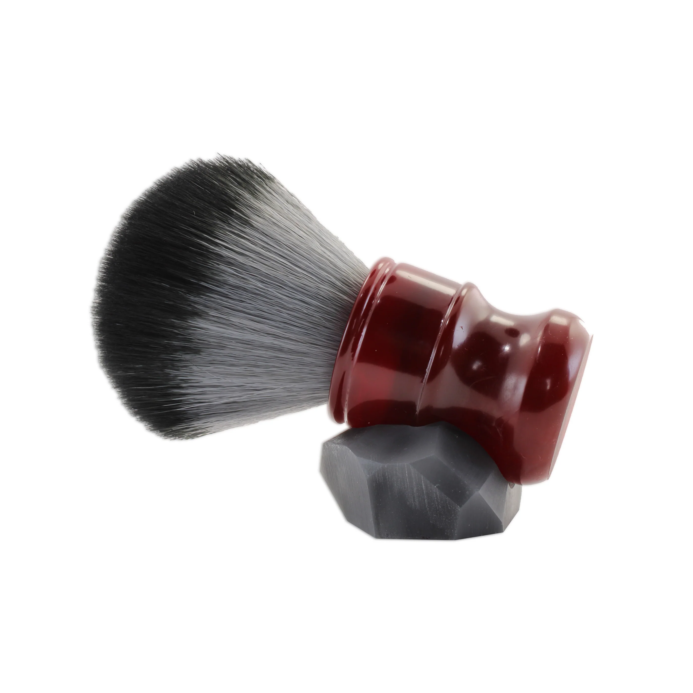 Cruisin Organics Dark Ruby Shaving Brush, an ideal match for our shaving soap to enhance your shaving ritual. Experience the pleasure of creating your own shaving cream lather, anticipate a pleasant revelation! Our brushes boast superior synthetic bristles, expertly anchored in artisan-crafted handles.

Also, take note of the distinctive stand for the brush! Our craftsman starts with a bespoke clay model, which is used to forge a mold. This mold is then meticulously shaped to produce a stand w