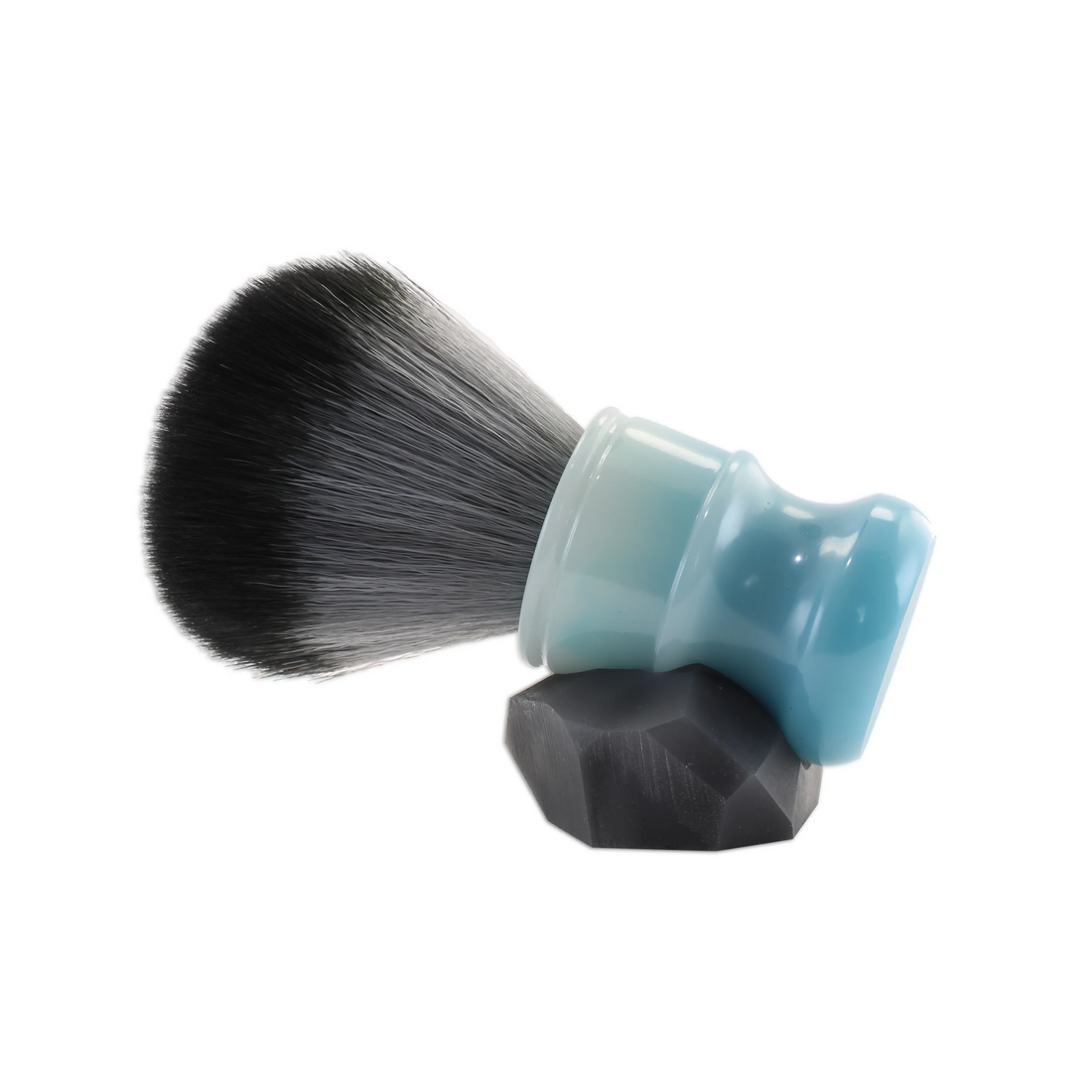 The Moon Cloud Shaving Brush features premium synthetic knots nestled in hand-poured bases for an exceptional shaving experience. 

Included in the package is a geometric brush stand, a creation of an artisan who initially sculpted the design in clay before casting it into a mold. This was then meticulously carved to achieve a rugged, minimalist geometric form.