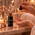 Hands dispensing Rose Gold Facial Oil from a dropper into a palm at an evening vanity